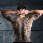 man_with_a_backpiece_christian_and_enlightenment_tattoo-_color